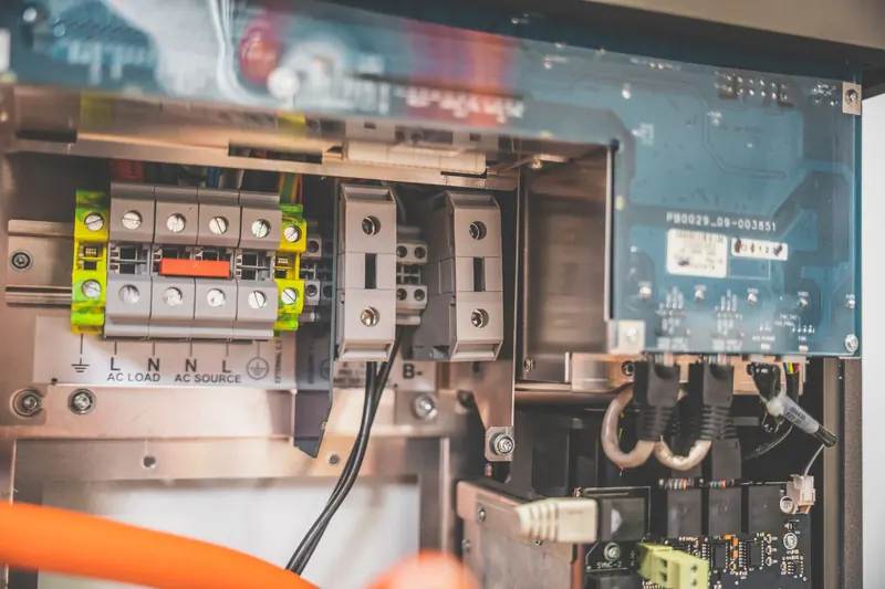 Open solar inverter showing terminals and circuit boards